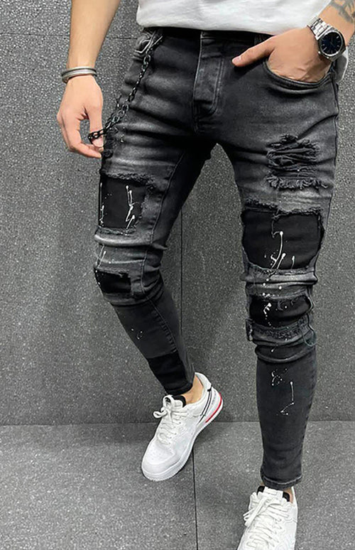 Modern man's ripped slim jeans exude confidence.