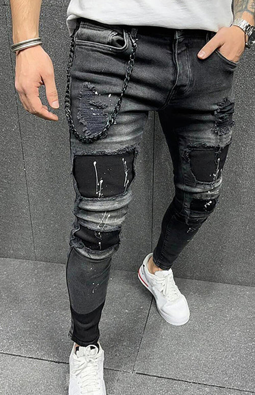 Modern man's ripped slim jeans exude confidence.