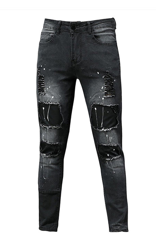 Modern man's ripped slim jeans exude confidence.